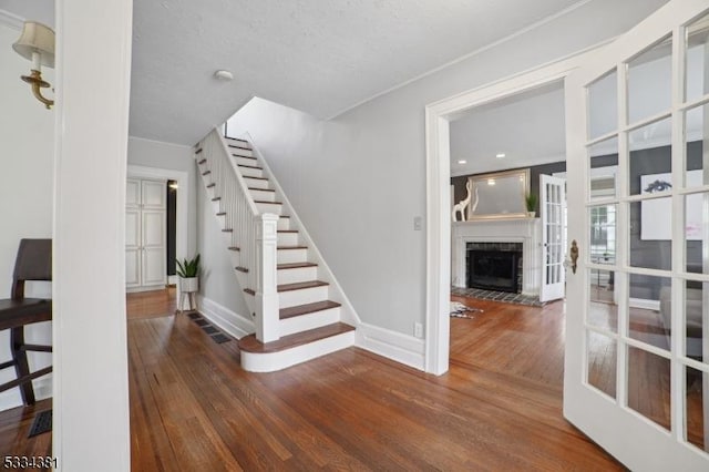 staircase featuring wood-type flooring and french doors