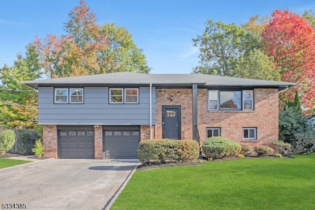 split foyer home featuring a garage and a front lawn