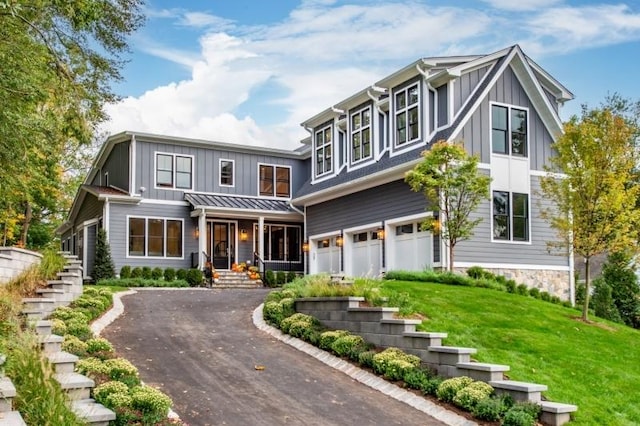 view of front of home with a garage and a front lawn