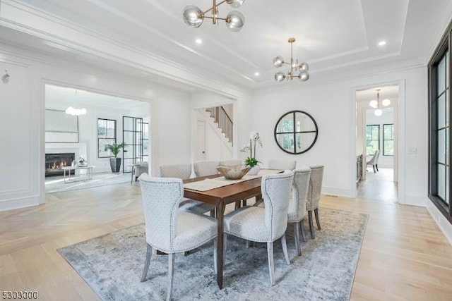 dining room with a tray ceiling and a chandelier