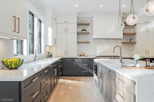 kitchen with white cabinetry, plenty of natural light, decorative light fixtures, and decorative backsplash