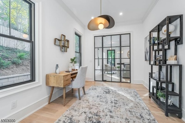 office area featuring ornamental molding and light hardwood / wood-style floors