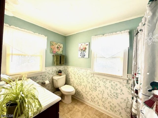 bathroom with crown molding and toilet