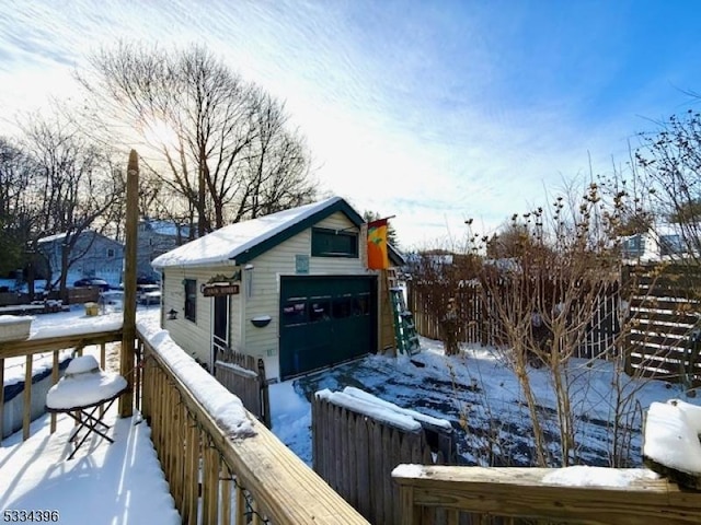 snow covered deck featuring a garage