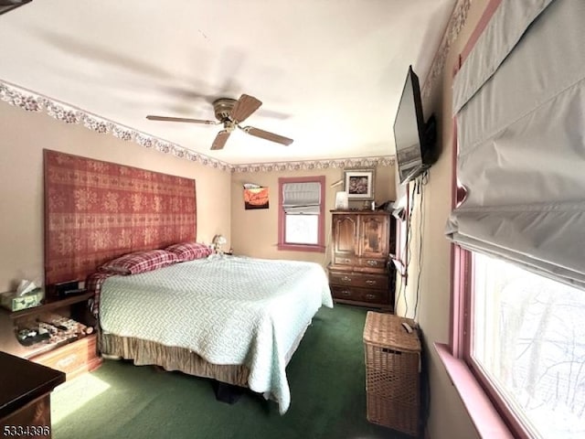 bedroom featuring multiple windows, carpet, and ceiling fan