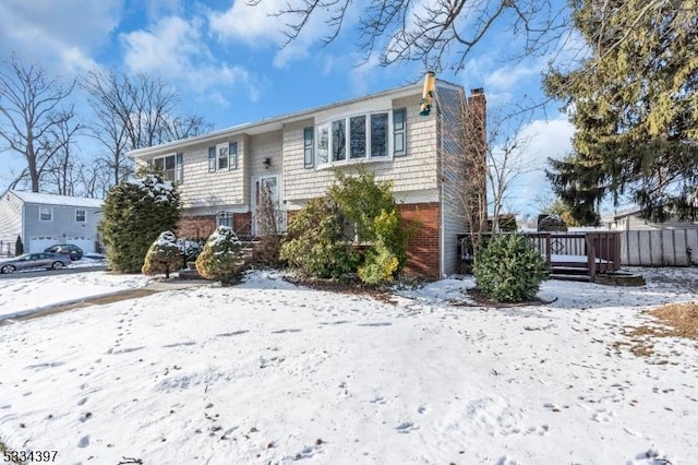 bi-level home with a wooden deck