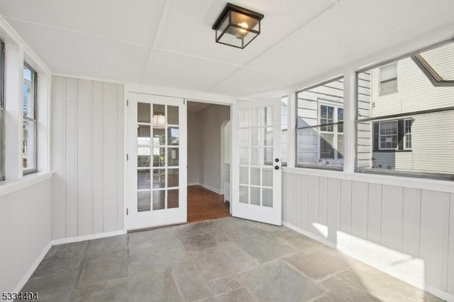 unfurnished sunroom with french doors and a wealth of natural light