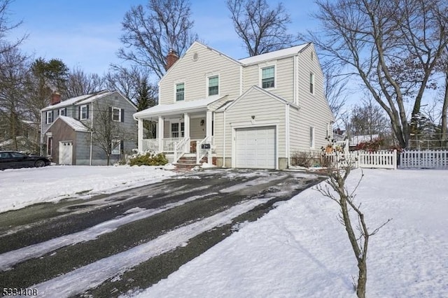 view of property with a garage and a porch