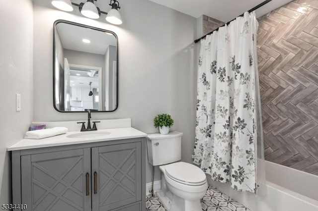 full bathroom featuring vanity, toilet, and shower / tub combo