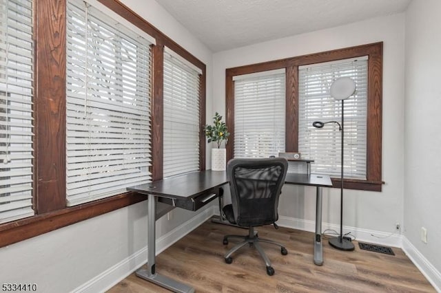 office space featuring hardwood / wood-style flooring and a textured ceiling