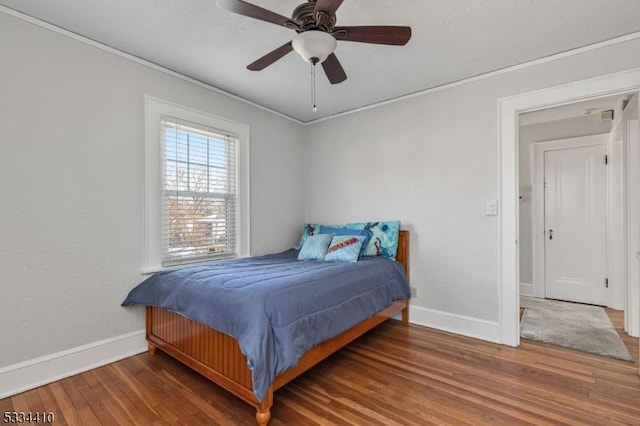 bedroom featuring crown molding, ceiling fan, and dark hardwood / wood-style floors