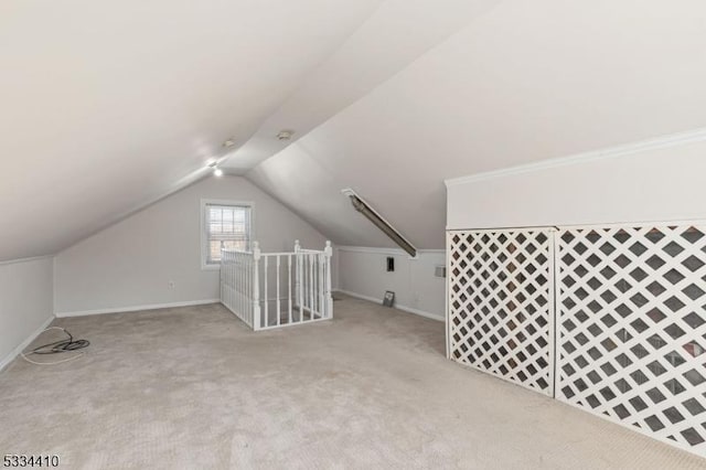 bonus room featuring light carpet and vaulted ceiling