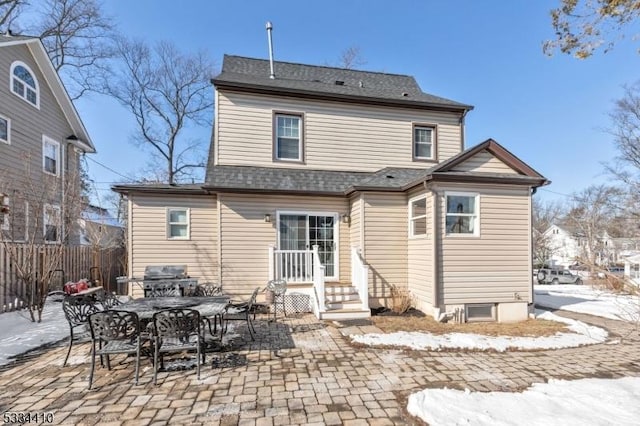 snow covered property with a patio area