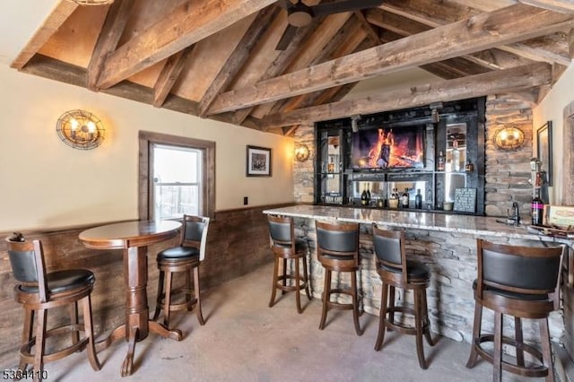 bar featuring lofted ceiling with beams