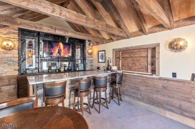 bar with high vaulted ceiling, wooden ceiling, and beamed ceiling