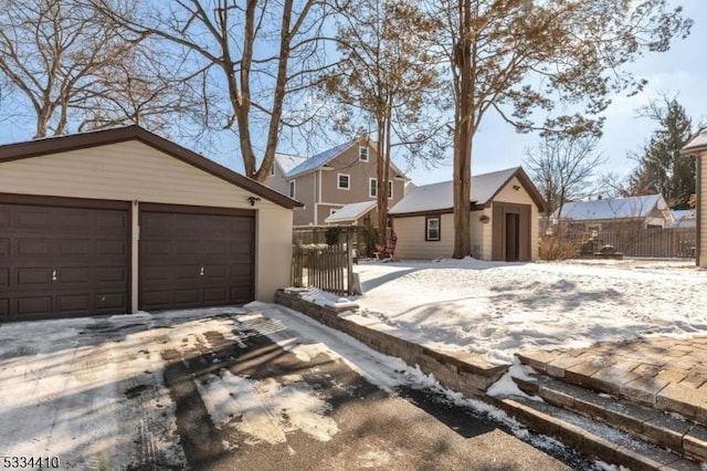 view of front of home featuring a garage and an outdoor structure