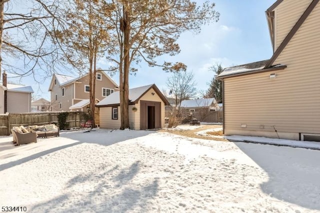 yard layered in snow featuring an outbuilding