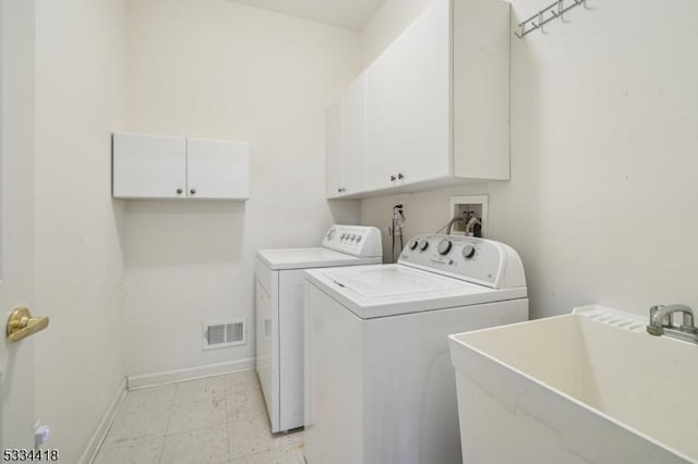 laundry area with sink, washer and clothes dryer, and cabinets