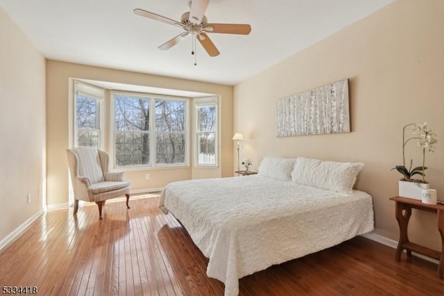 bedroom with hardwood / wood-style flooring and ceiling fan