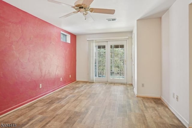 unfurnished room featuring ceiling fan and light wood-type flooring