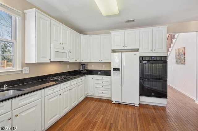 kitchen with white cabinets and black appliances