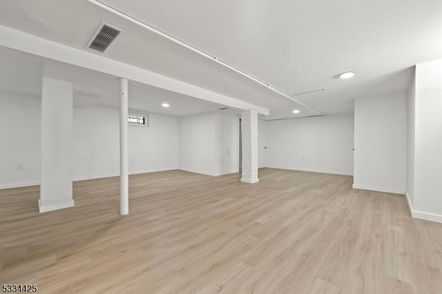 basement with light hardwood / wood-style floors