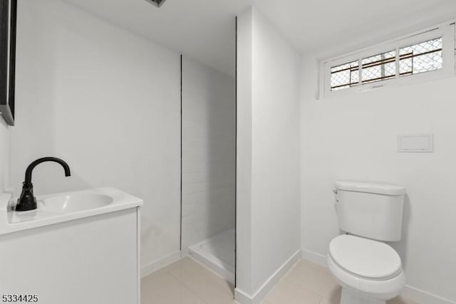 bathroom with vanity, toilet, tile patterned flooring, and a shower