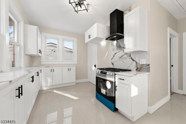 kitchen with white cabinetry, wall chimney exhaust hood, and stainless steel gas range oven