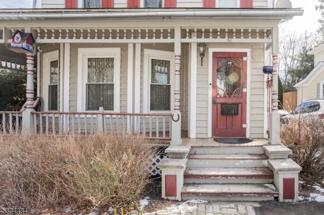 entrance to property featuring a porch