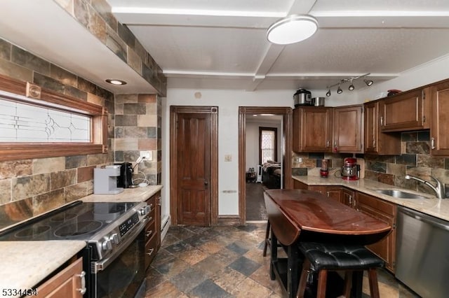 kitchen featuring stainless steel appliances, sink, and decorative backsplash