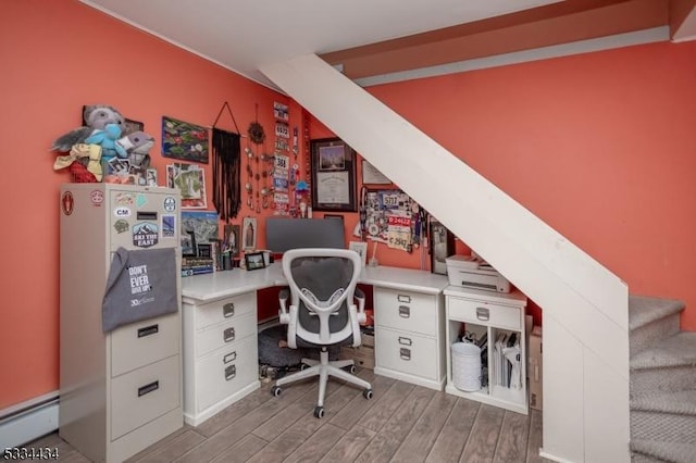 office area with light hardwood / wood-style floors and baseboard heating