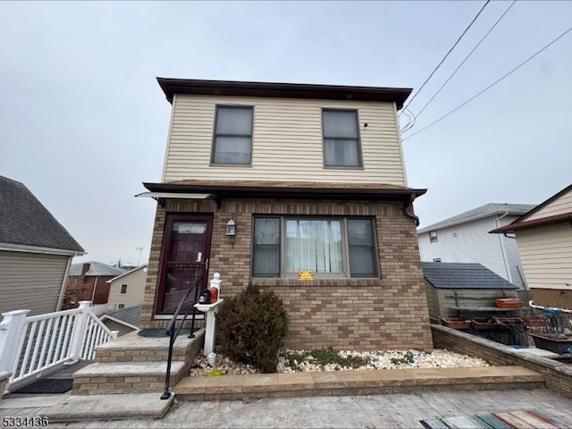 view of front of house featuring brick siding