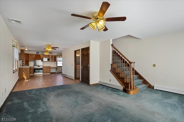 unfurnished living room with a baseboard radiator, visible vents, dark carpet, and stairs