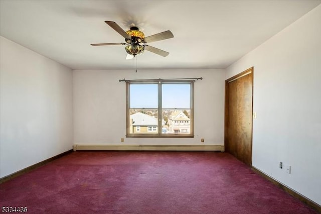 carpeted empty room with a baseboard radiator, ceiling fan, and baseboards