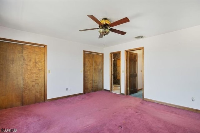 unfurnished bedroom with carpet, multiple closets, visible vents, ceiling fan, and baseboards