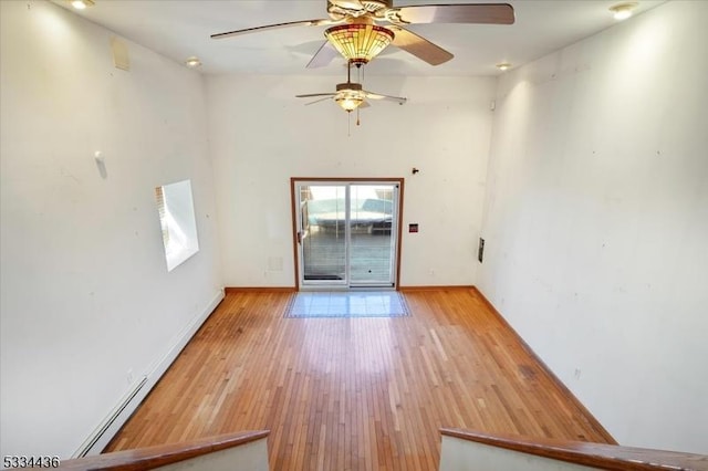 interior space featuring baseboards and wood finished floors