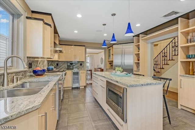 kitchen featuring beverage cooler, visible vents, open shelves, a sink, and built in appliances