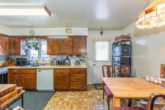 kitchen featuring white dishwasher and sink