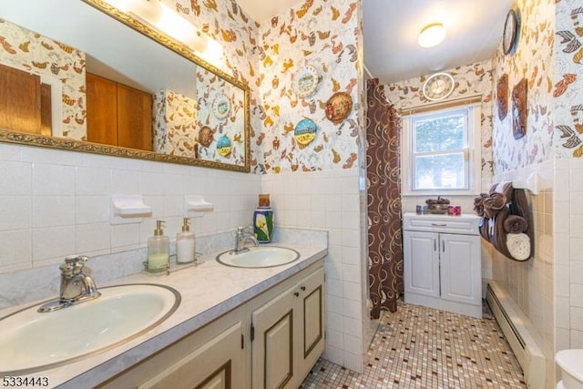 bathroom with toilet, tile walls, a baseboard radiator, vanity, and tile patterned flooring