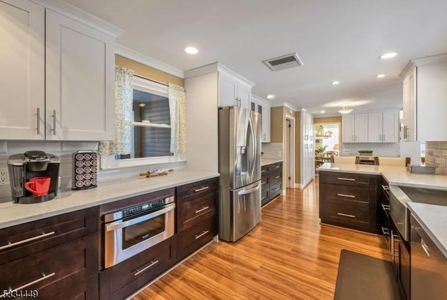 kitchen with white cabinetry and appliances with stainless steel finishes