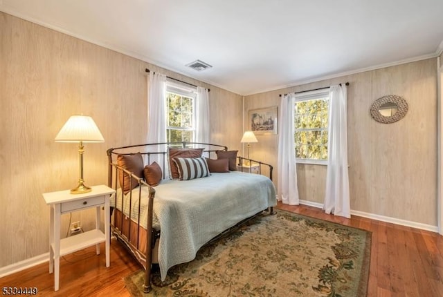 bedroom featuring dark wood-type flooring and crown molding