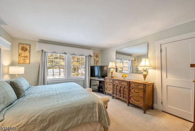 bedroom featuring light colored carpet and ornamental molding