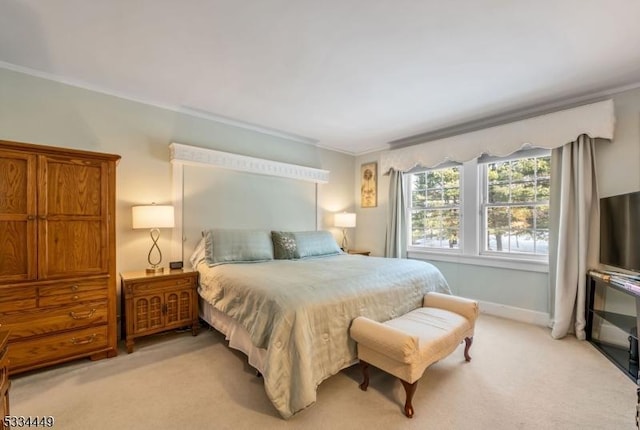 bedroom with crown molding and light colored carpet