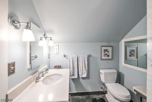 bathroom with lofted ceiling, vanity, and toilet