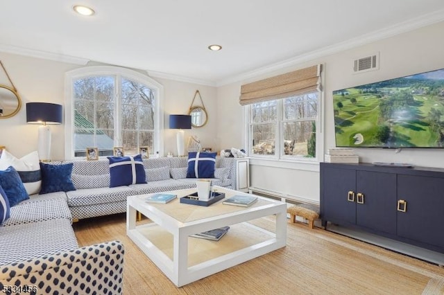 living room featuring crown molding and hardwood / wood-style flooring