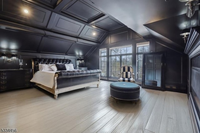 bedroom featuring coffered ceiling, vaulted ceiling, and light hardwood / wood-style flooring