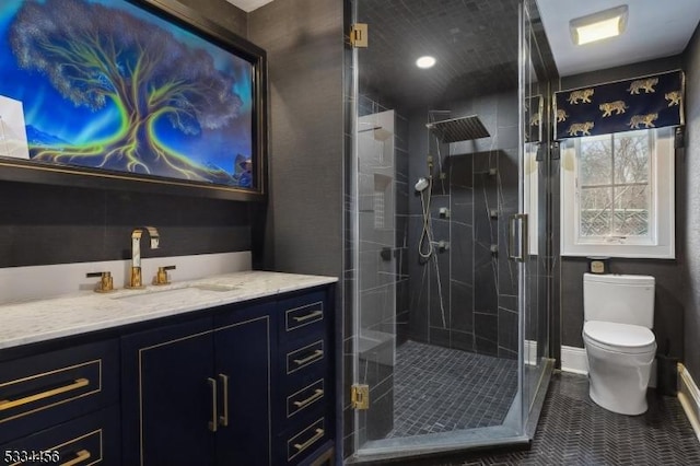 bathroom featuring vanity, tile patterned flooring, a shower with shower door, and toilet