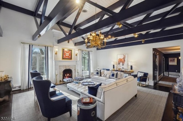 living room featuring a notable chandelier, beam ceiling, a high end fireplace, and a healthy amount of sunlight