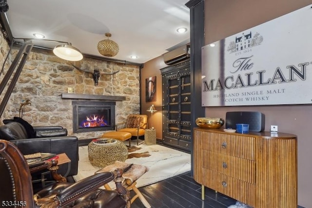 living room with a stone fireplace and hardwood / wood-style flooring