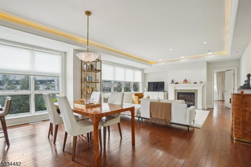 dining space featuring dark wood-type flooring and a tray ceiling